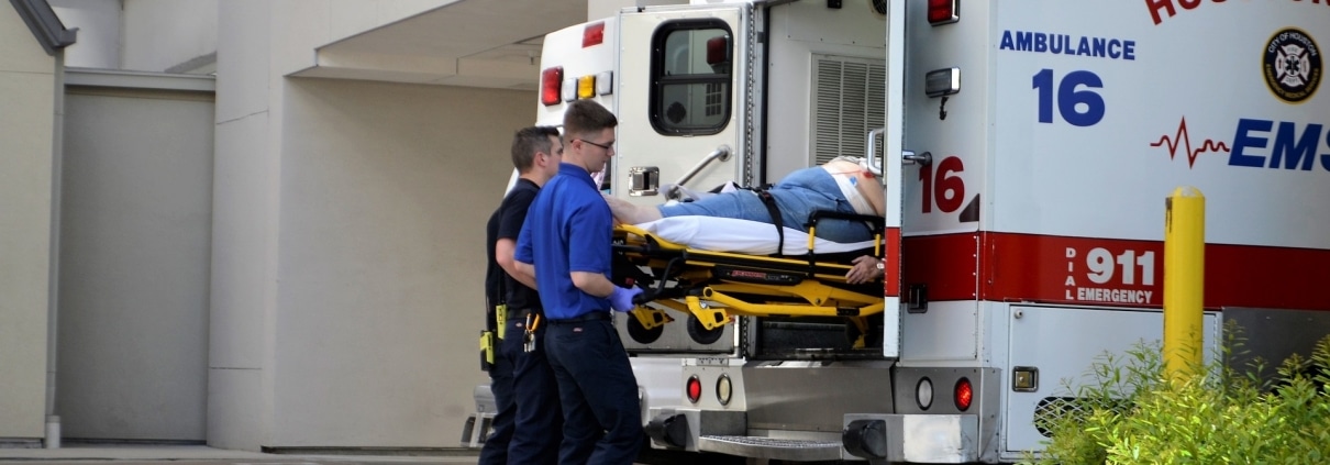 First responders lifting a stretcher into an ambulance