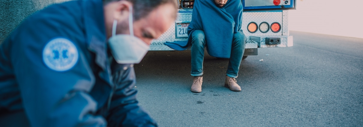 Masked paramedic retrieving supplies