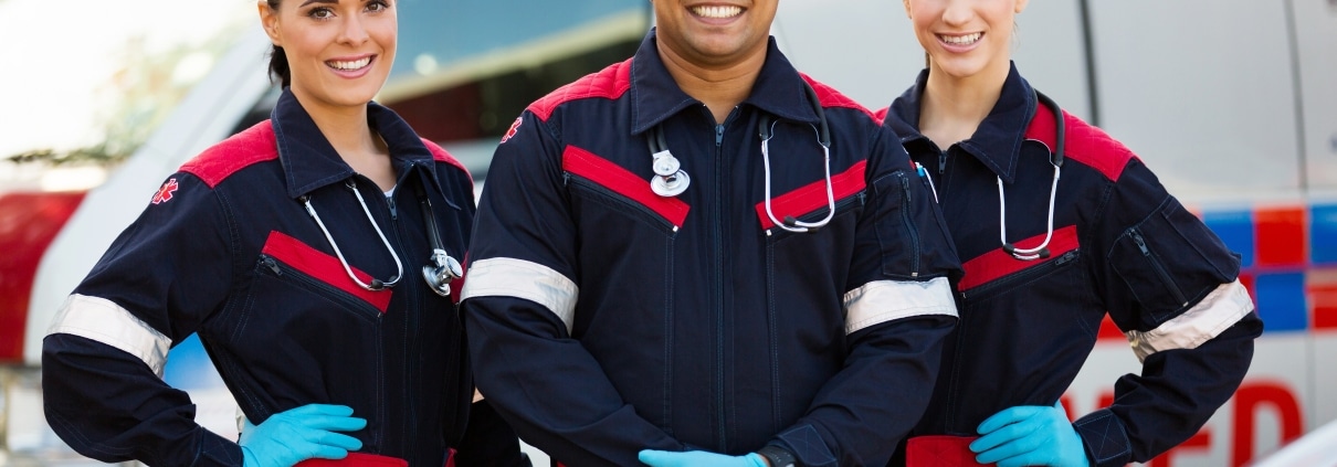 EMS professionals in front of an ambulance