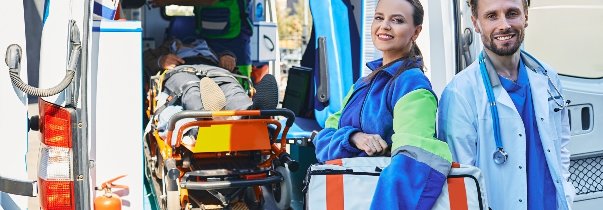 Medical workers standing beside an ambulance