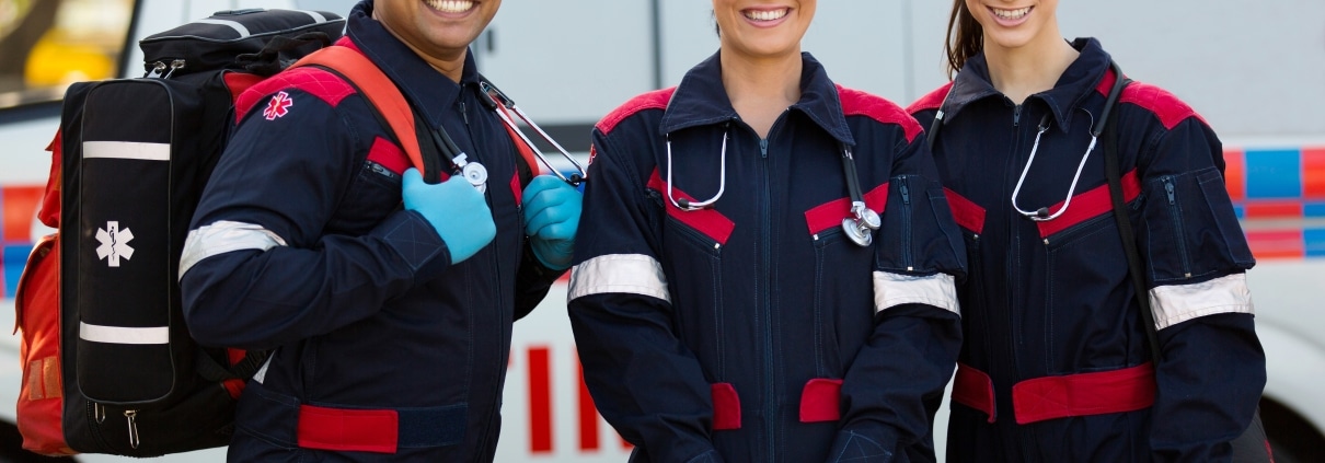 Group of EMS professionals next to ambulance