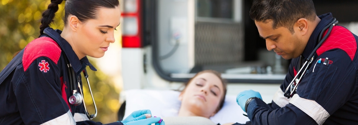 EMS professionals assisting a woman