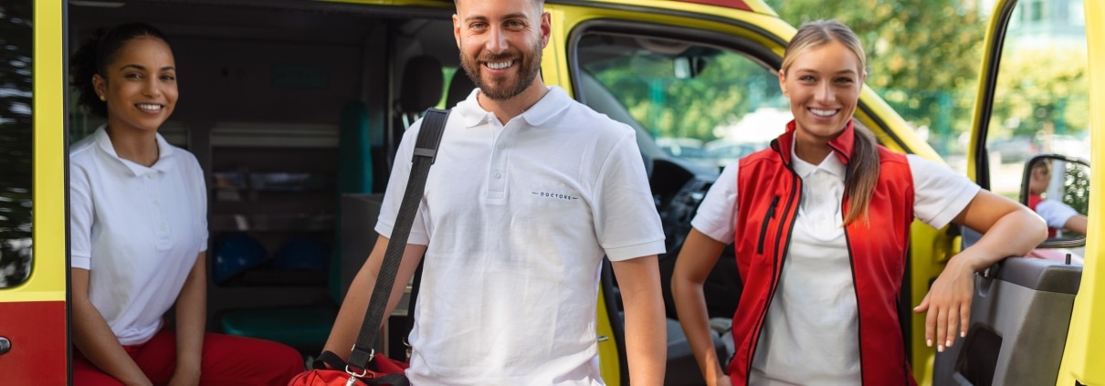 Three smiling EMS professionals