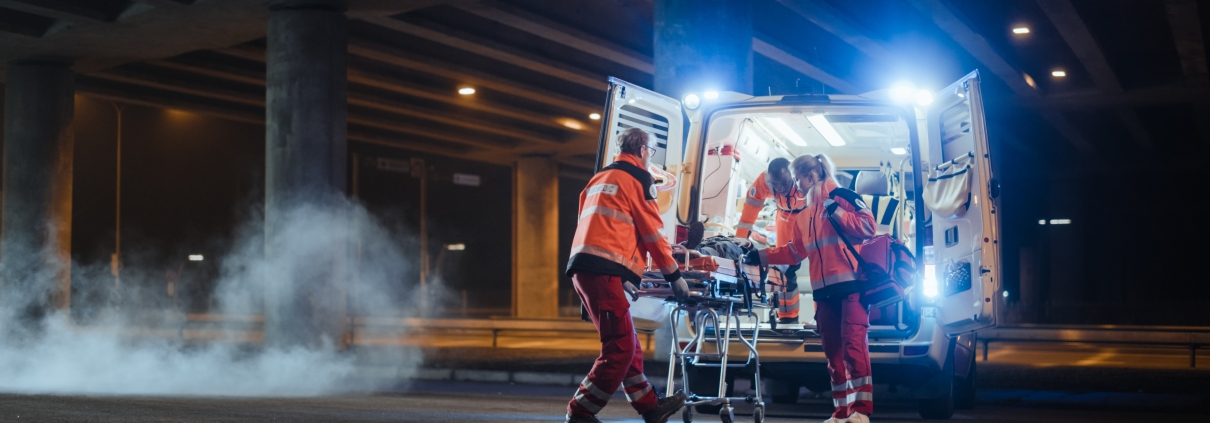 Team of EMS professionals helping an injured person