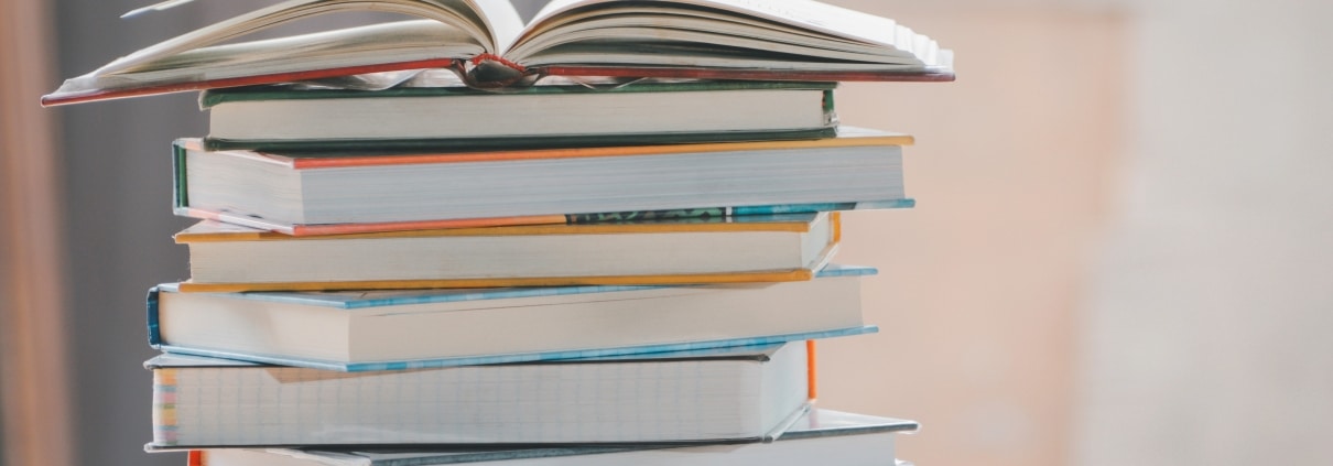 Stack of books with an open book on top