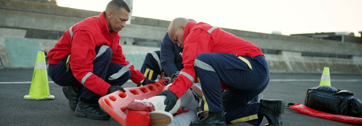 EMS team transporting a car crash victim on the road