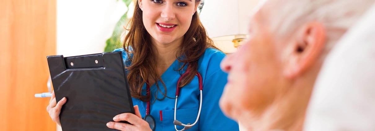 Young nurse speaking with an elderly man